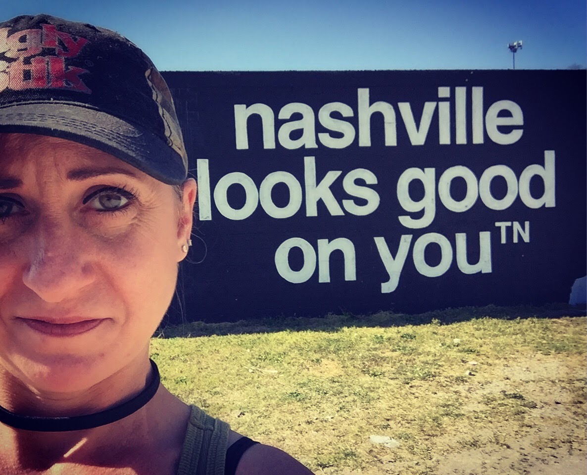 Cara in front of the Nashville Looks Good On You mural