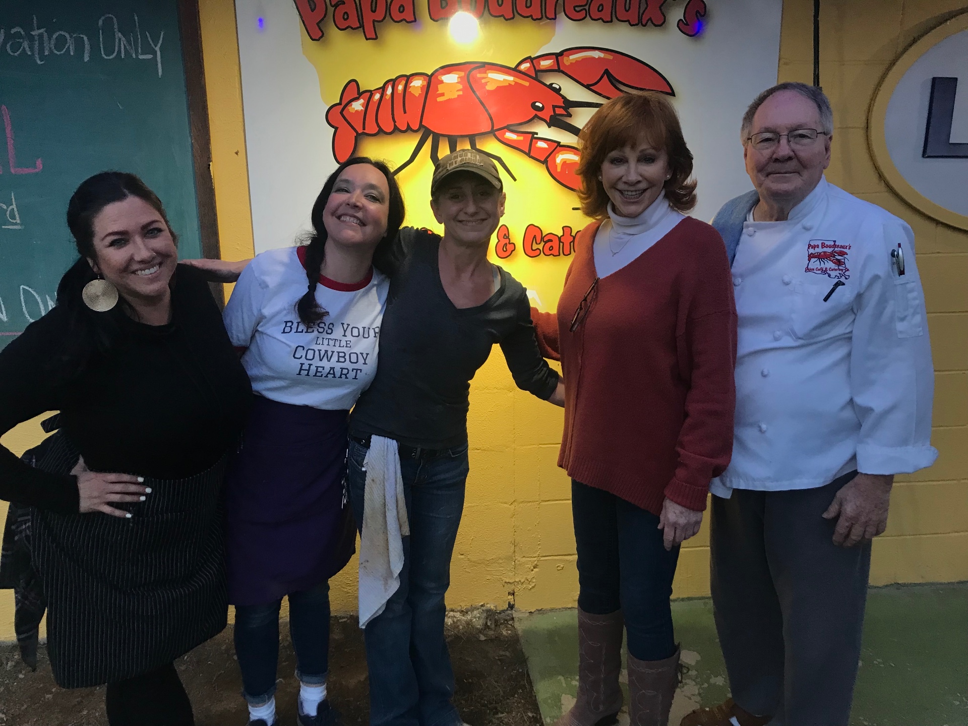 Cara with the kitchen crew at a Cajun cafe and catering company in Nashville